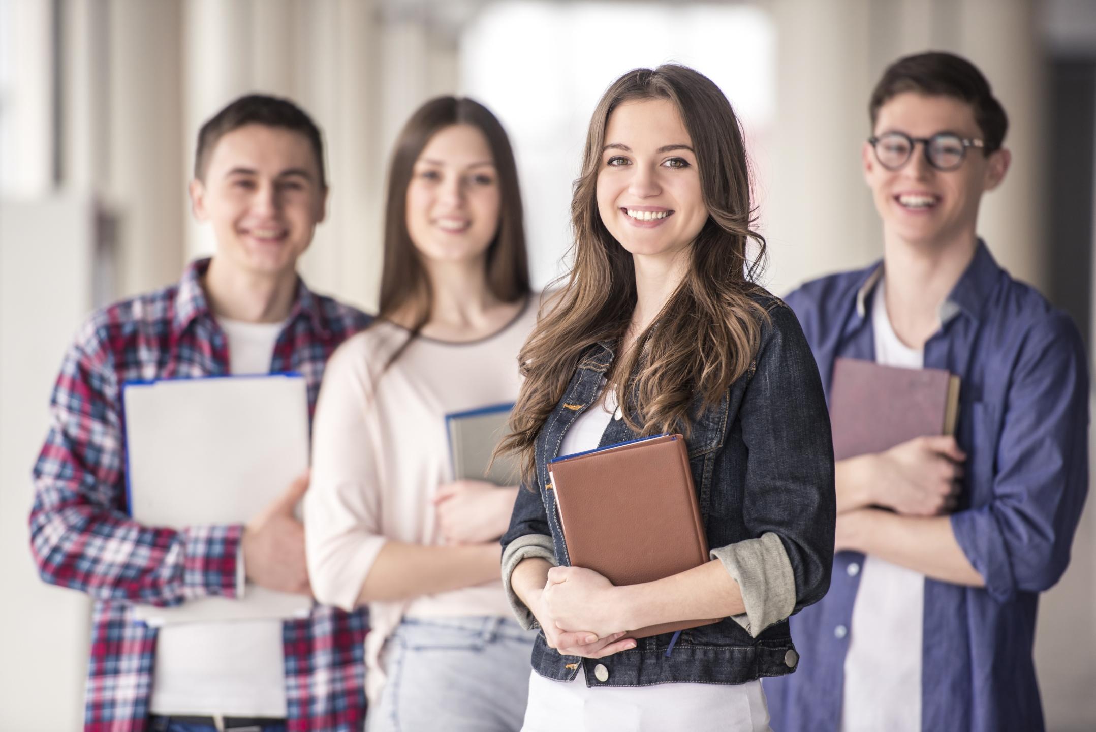 Group of happy young students in a university.